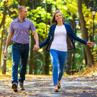 a middle-aged couple taking a walk around the neighbourhood